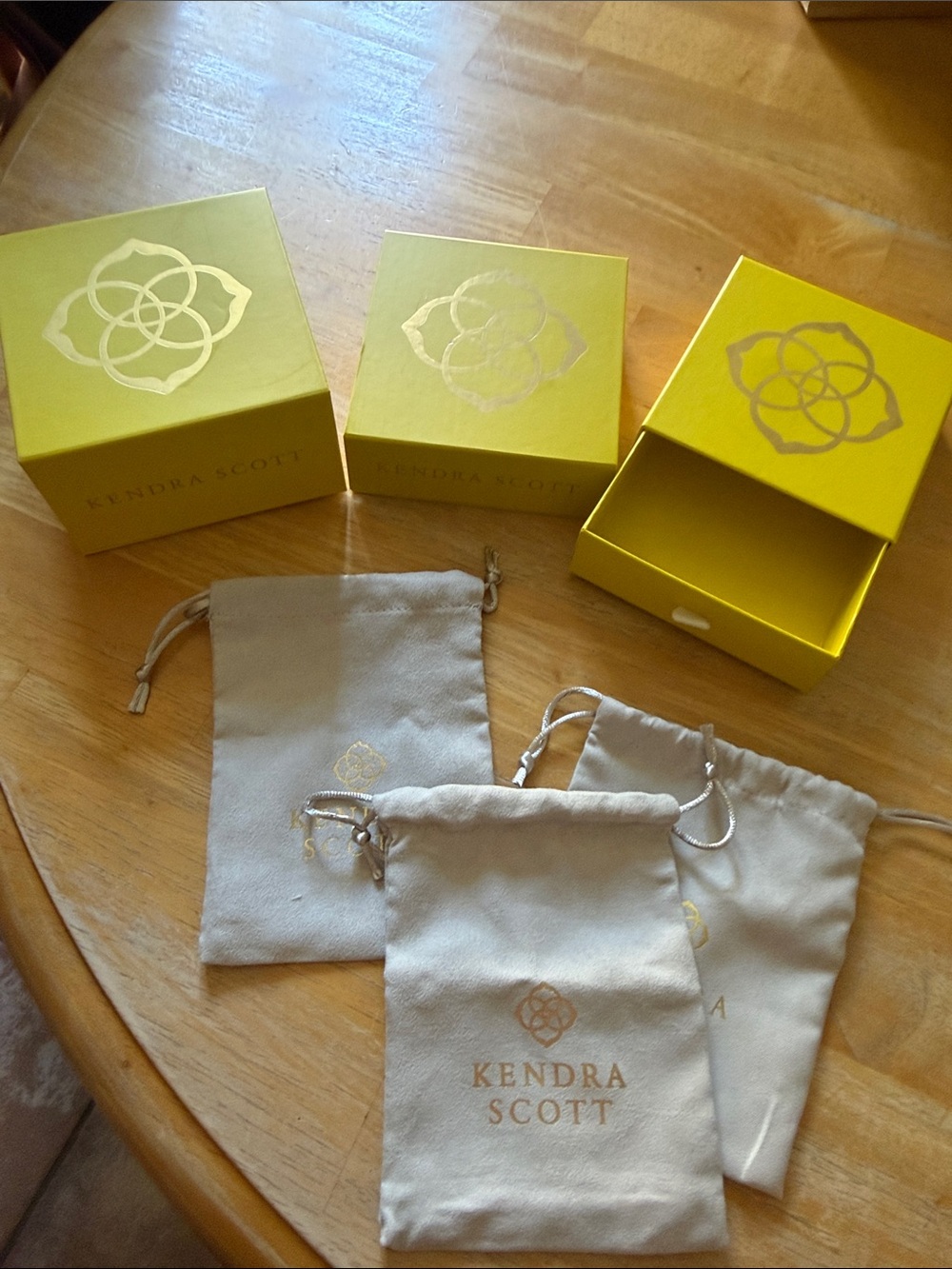 Kendra Scott Yellow Jewelry Boxes with Beige Drawstring Pouches